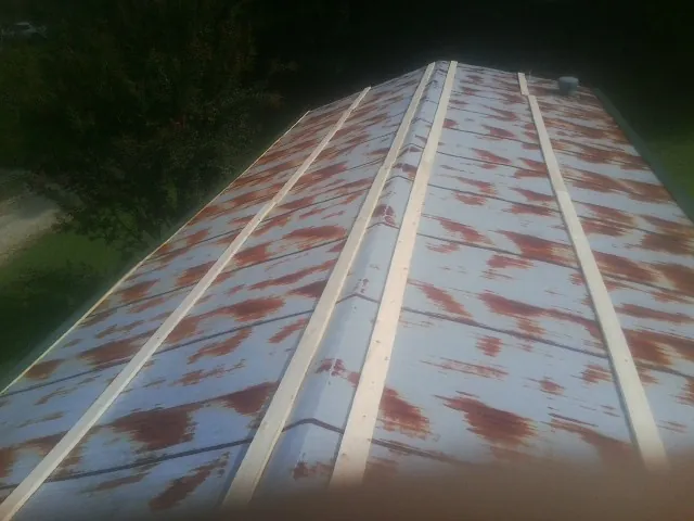 Rusted metal roof panels with new wood purlins before replacement — Storm Damage Roof Repair in Lapel by Roofing Brothers